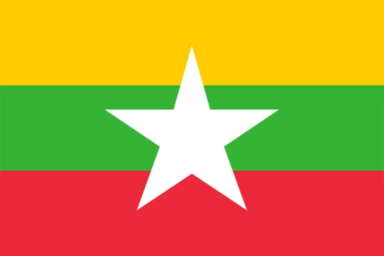 Flag of myanmar with three horizontal stripes in yellow, green, and red from top to bottom, and a large white five-pointed star in the center.